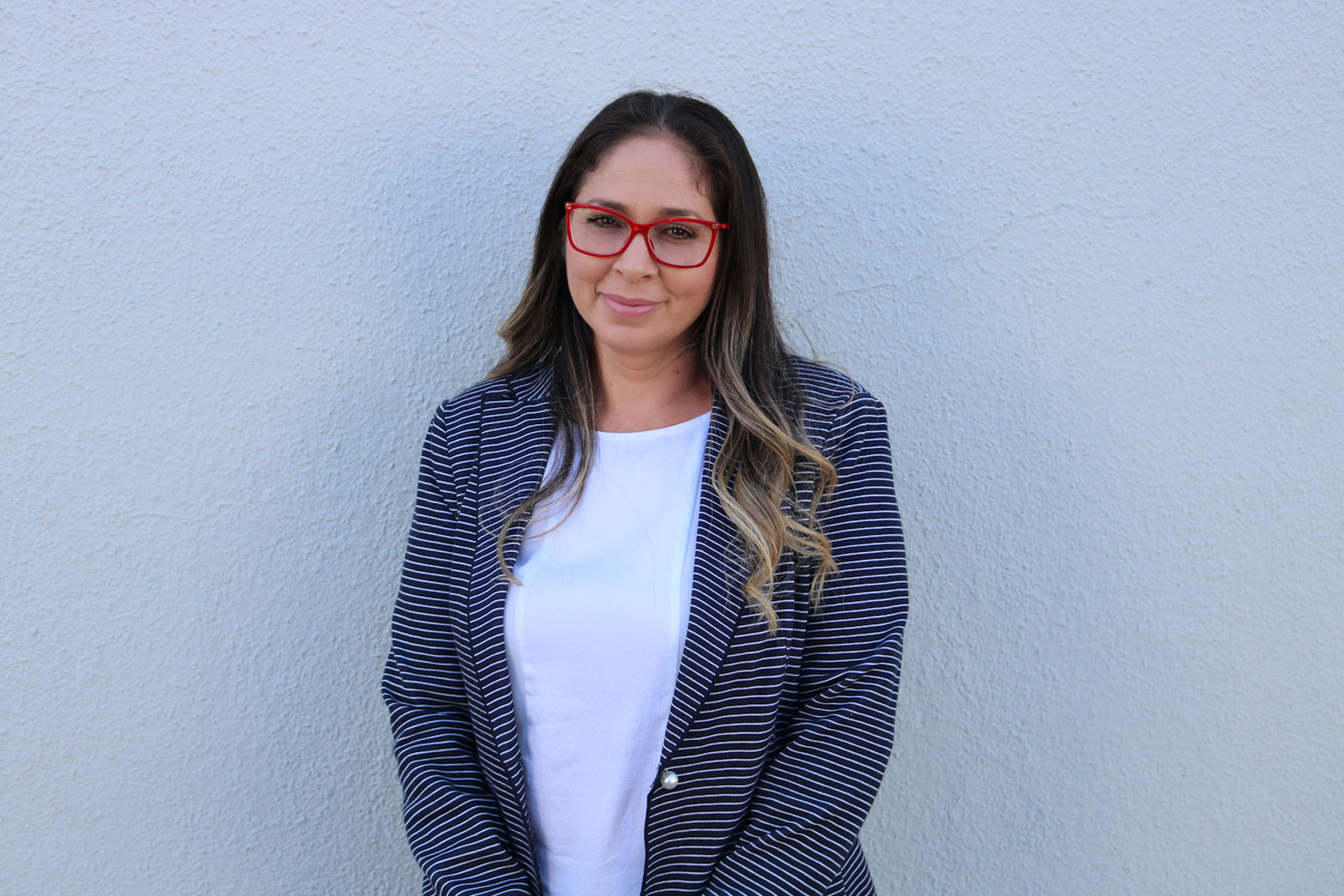 A woman wearing glasses and a jacket