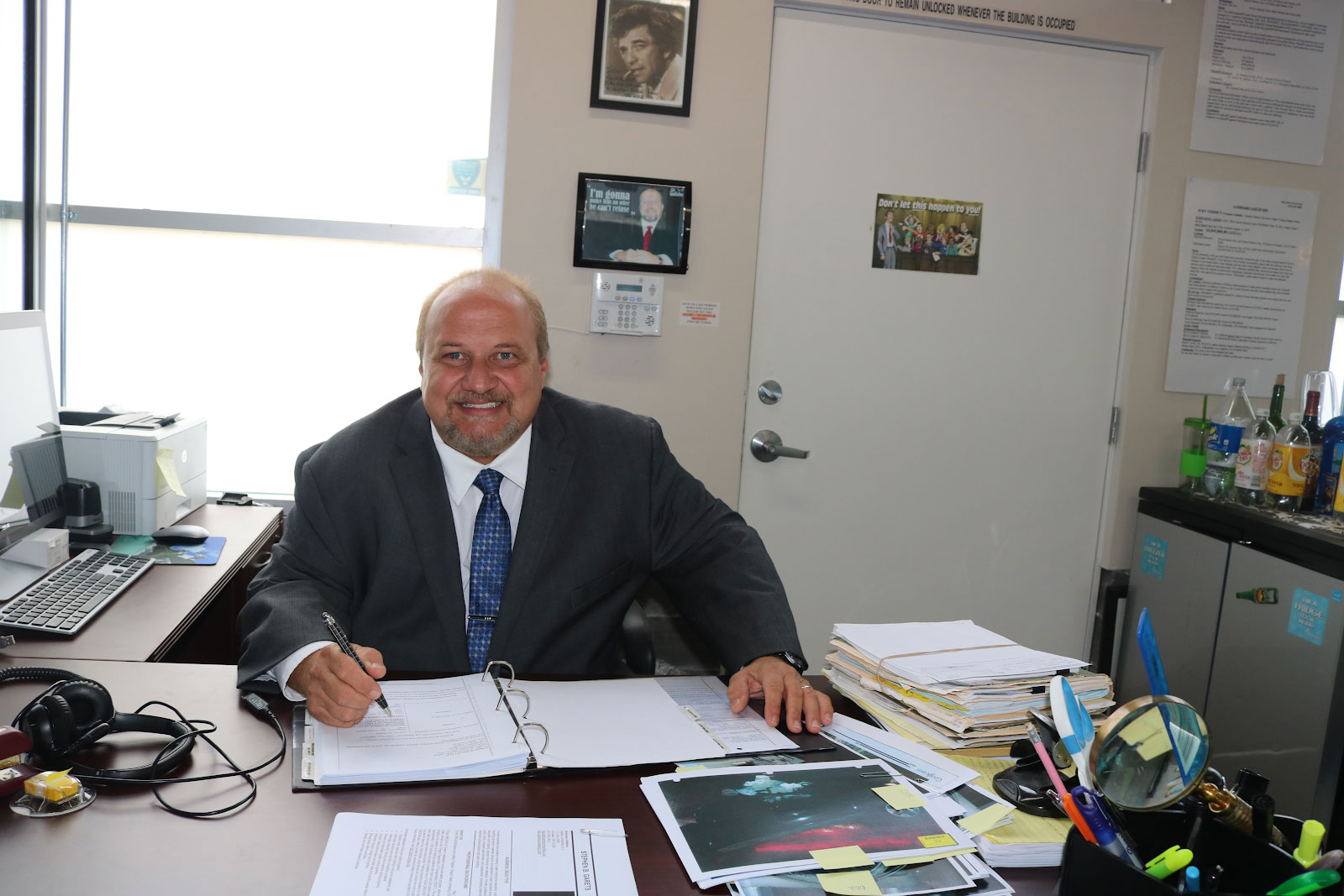 A man sitting at his desk in an office.